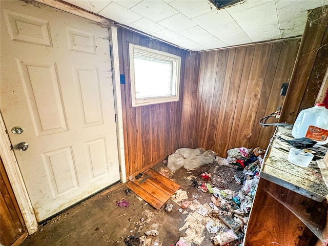 miscellaneous room featuring wood walls