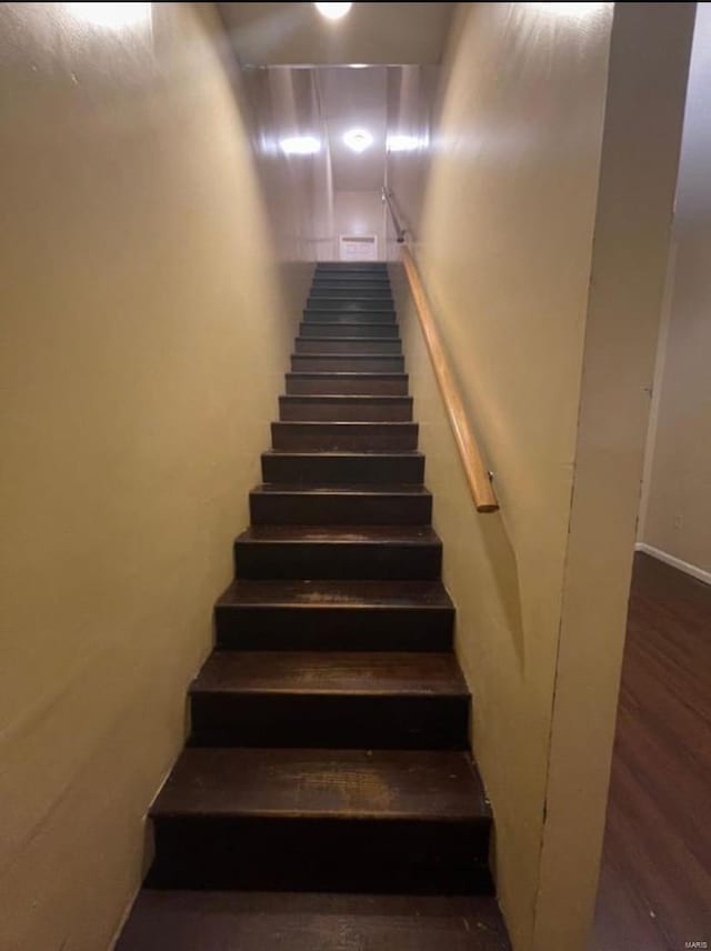 stairs featuring hardwood / wood-style flooring