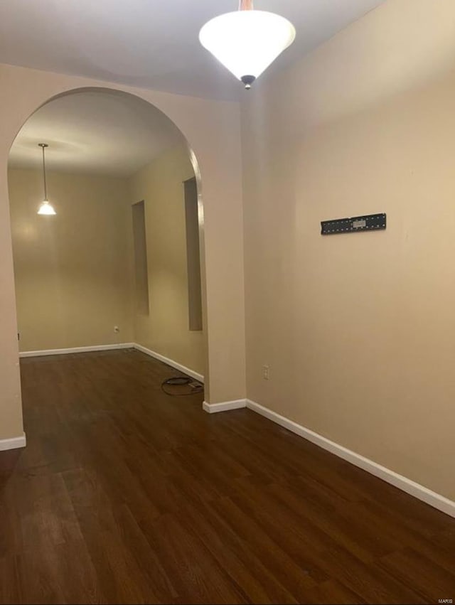 empty room with dark hardwood / wood-style floors