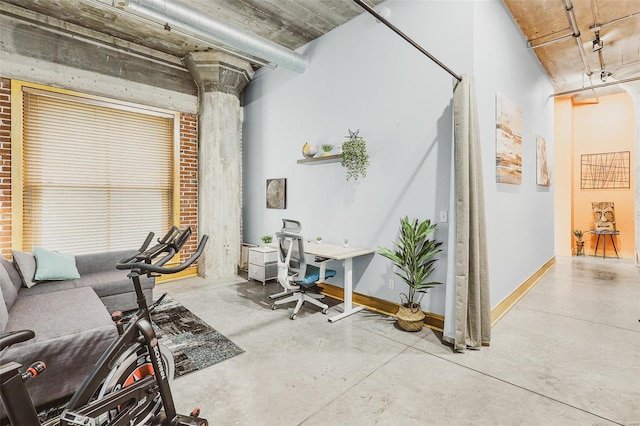 living room featuring ornate columns and concrete floors