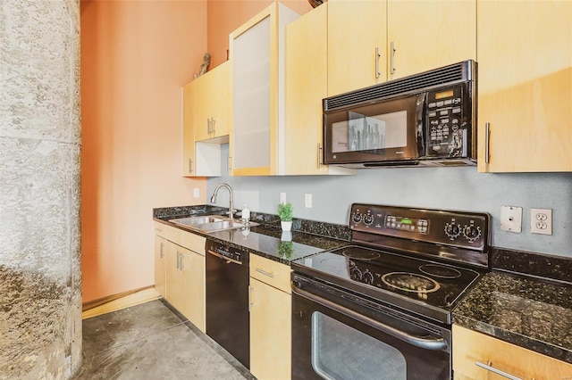 kitchen featuring cream cabinets, sink, dark stone counters, concrete flooring, and black appliances