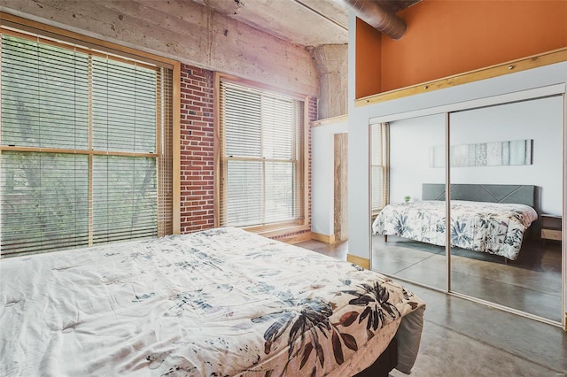 bedroom featuring a closet and concrete flooring