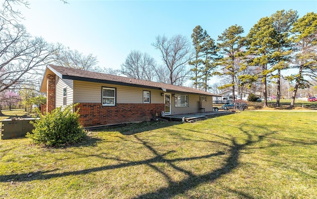 back of property featuring a lawn