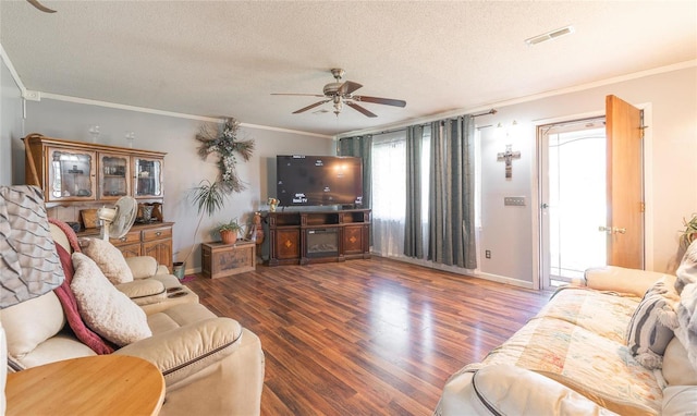 living room with crown molding, ceiling fan, and dark hardwood / wood-style flooring