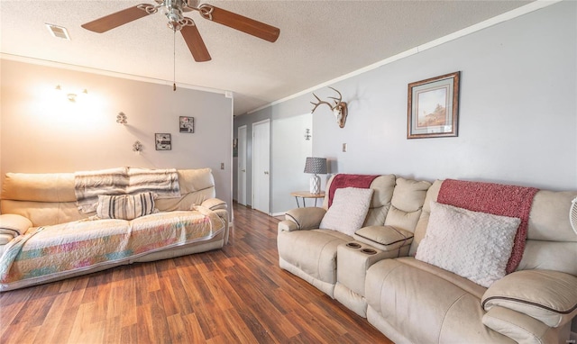 living room featuring ceiling fan, crown molding, dark hardwood / wood-style floors, and a textured ceiling