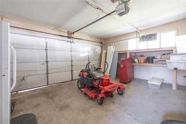 garage featuring white fridge and a garage door opener