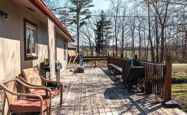 view of patio / terrace featuring a fire pit, area for grilling, and a wooden deck