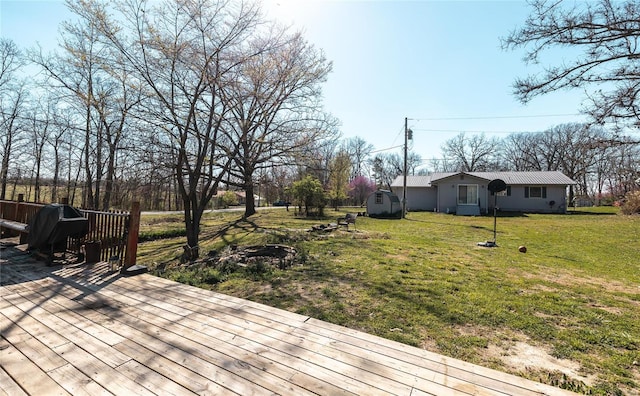 deck with a storage shed and a yard