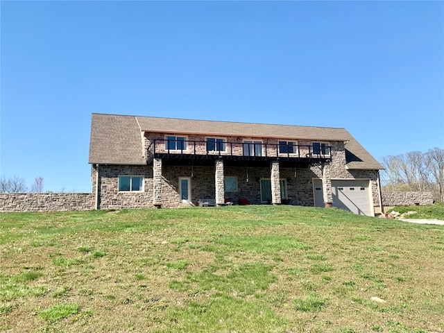 rear view of house featuring a yard and a garage