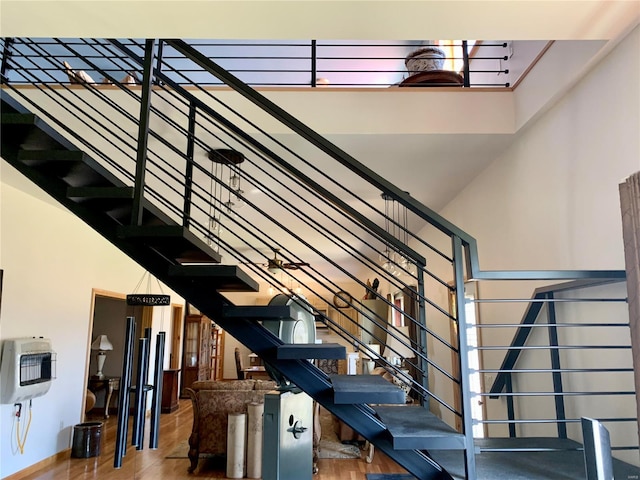 staircase featuring a towering ceiling