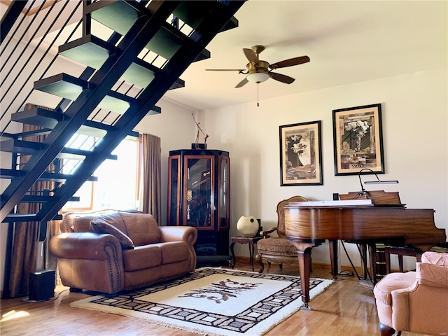 living room with ceiling fan and hardwood / wood-style flooring