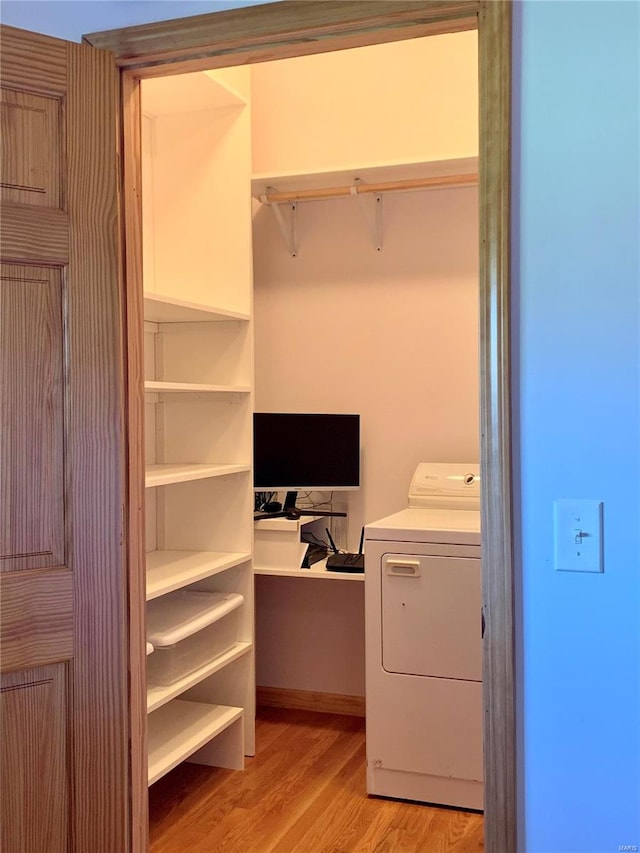 washroom with light hardwood / wood-style floors and washer / clothes dryer