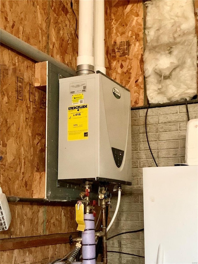 utility room featuring tankless water heater