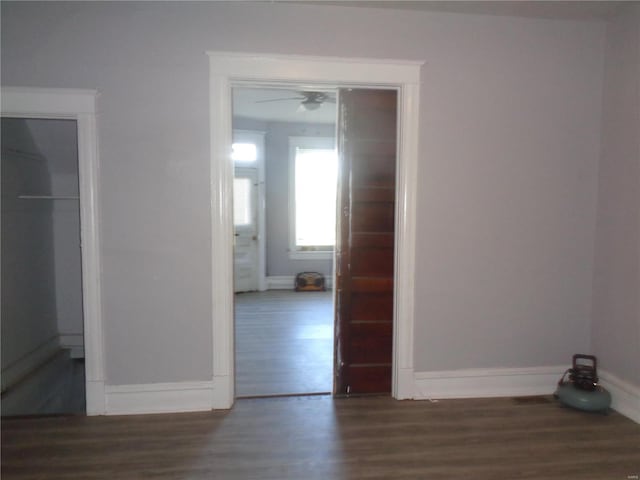 unfurnished room featuring ceiling fan and dark hardwood / wood-style flooring