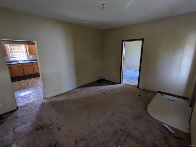 empty room with sink and light tile flooring