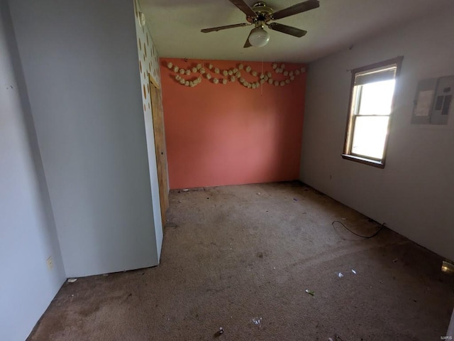 unfurnished room featuring ceiling fan and carpet