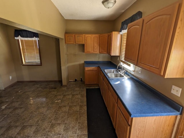 kitchen with sink and dark tile flooring