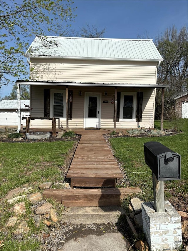 view of front of house with a front yard and a porch