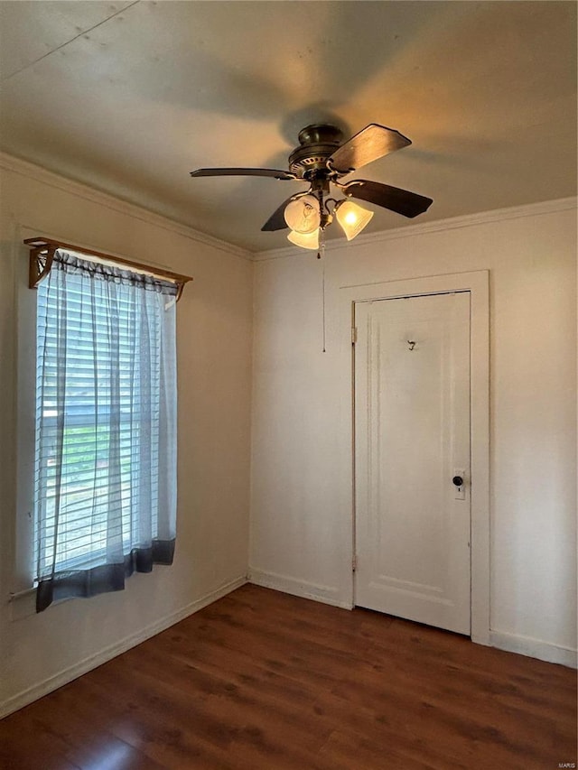 empty room featuring ornamental molding, ceiling fan, and dark hardwood / wood-style floors