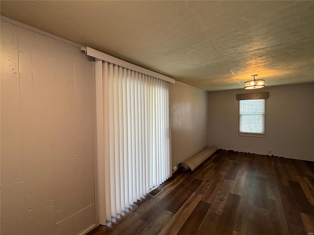 empty room featuring dark hardwood / wood-style flooring