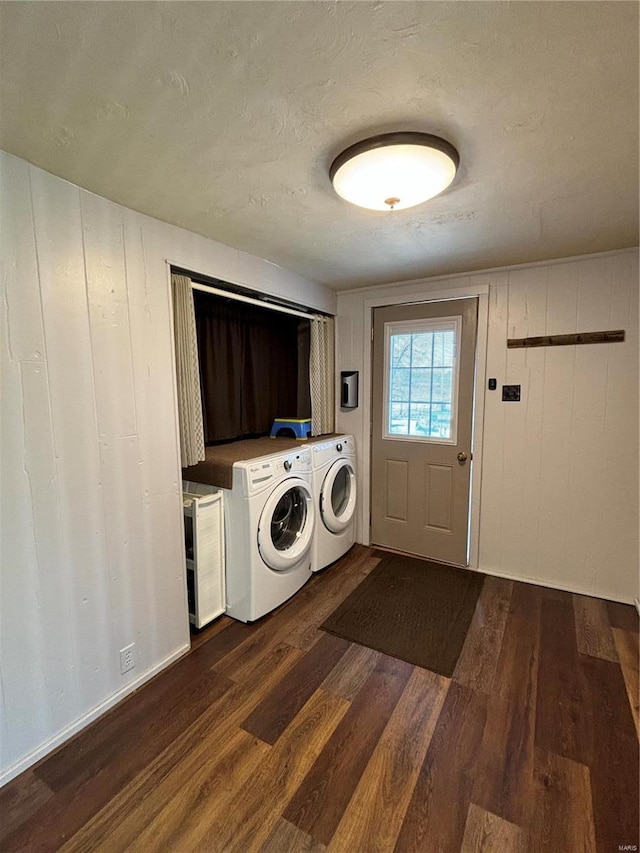 laundry room with washing machine and dryer and dark hardwood / wood-style floors