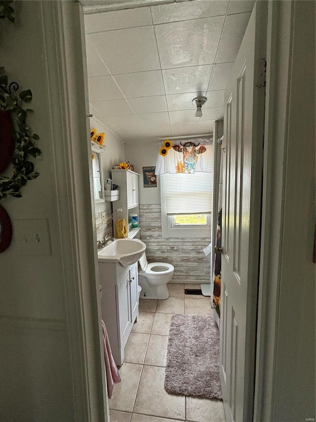 bathroom featuring vanity, tile floors, and toilet