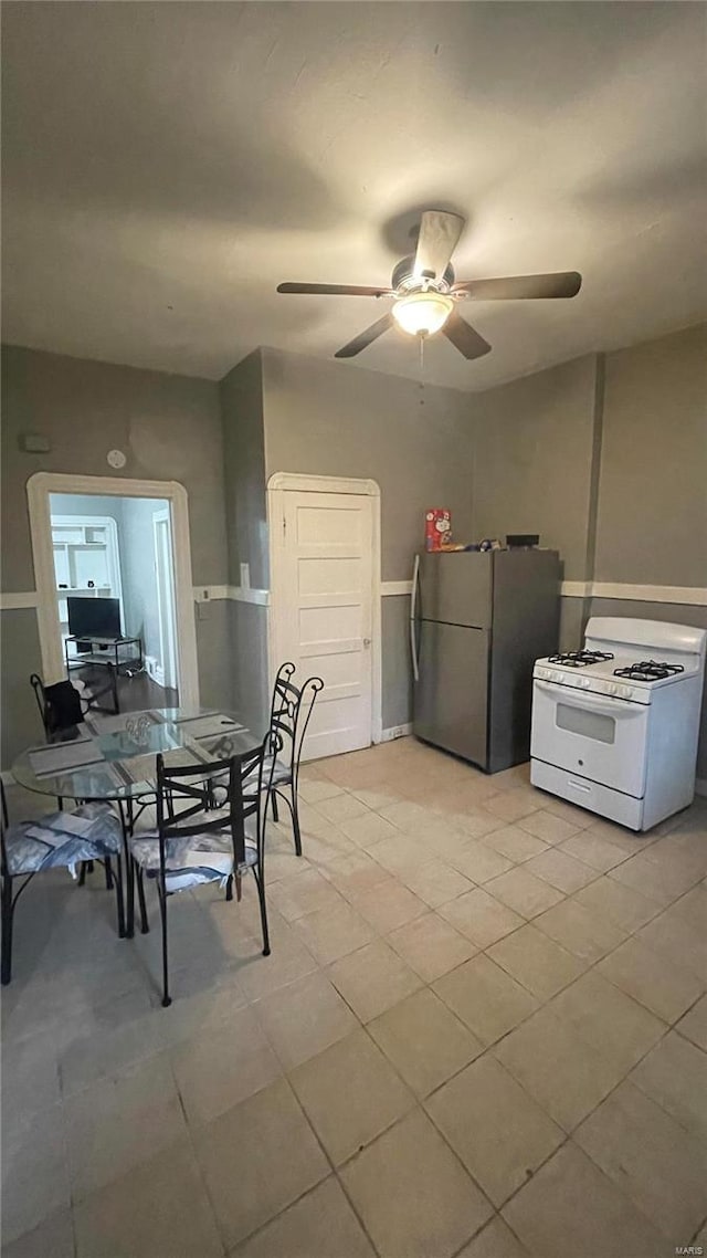 dining area with light tile floors and ceiling fan