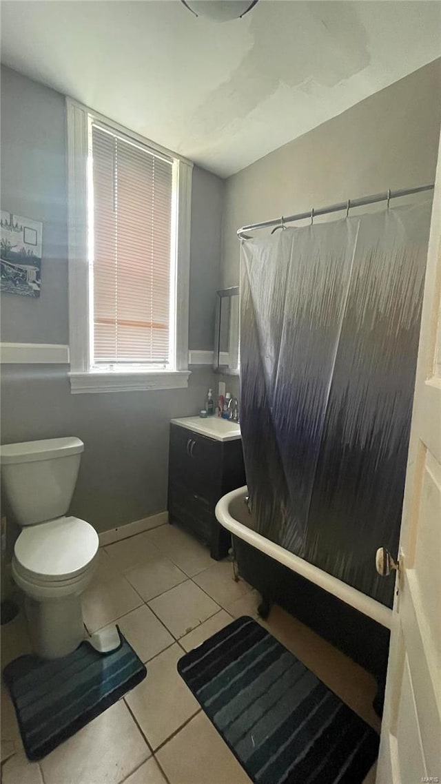 bathroom featuring tile flooring, toilet, and vanity