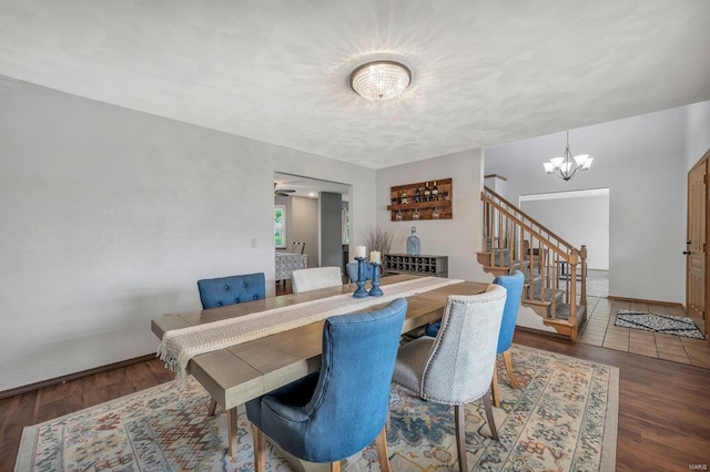 dining room featuring an inviting chandelier and dark tile flooring