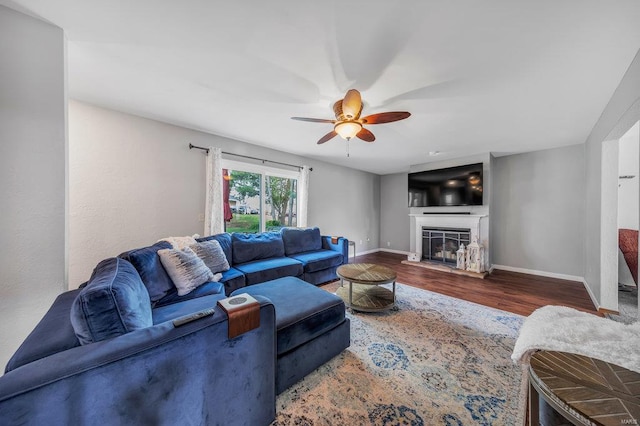 living room with ceiling fan and dark hardwood / wood-style floors