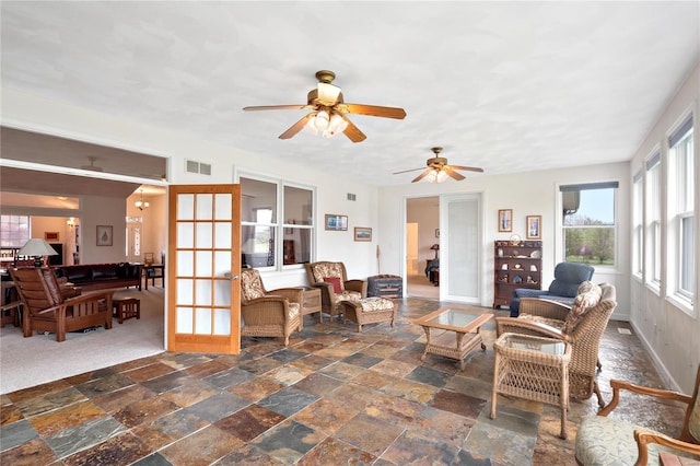 interior space with ceiling fan and french doors