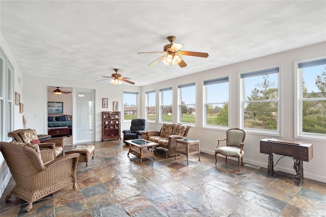 living room featuring ceiling fan, tile flooring, and plenty of natural light