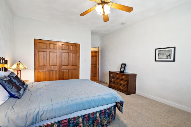 carpeted bedroom with ceiling fan and a closet