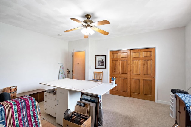 carpeted office with ceiling fan