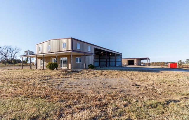 rear view of property with an outdoor structure