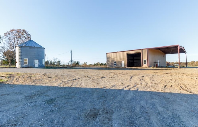 view of yard with an outdoor structure and a carport