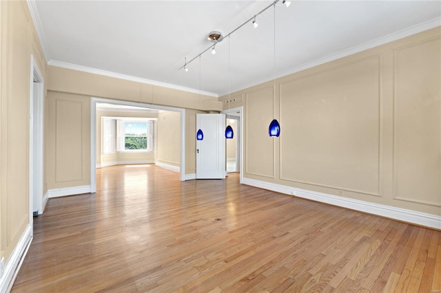 unfurnished room featuring light hardwood / wood-style flooring, crown molding, and rail lighting