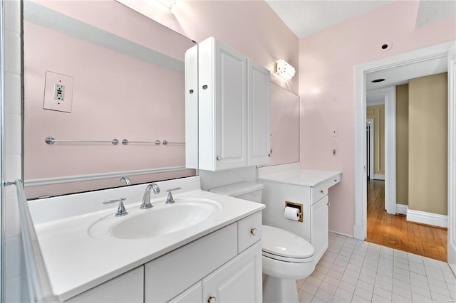 bathroom featuring vanity, hardwood / wood-style flooring, and toilet