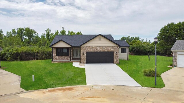 view of front of property featuring a garage and a front lawn