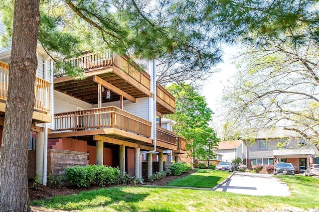 back of property featuring a yard and a deck