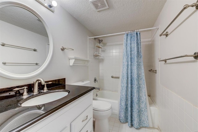 full bathroom with toilet, shower / tub combo with curtain, a textured ceiling, vanity, and tile floors