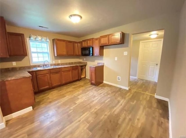 kitchen with light hardwood / wood-style flooring and sink