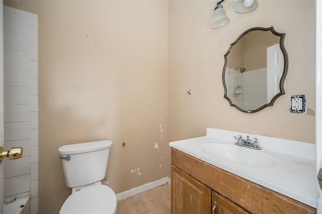 bathroom featuring hardwood / wood-style flooring, toilet, and vanity