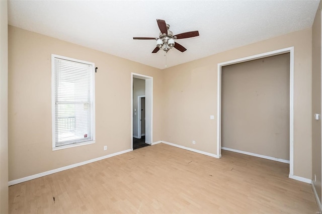 unfurnished bedroom with light hardwood / wood-style flooring and ceiling fan