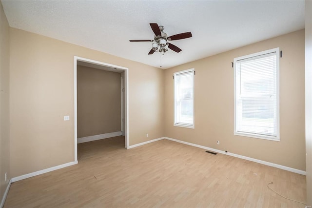 unfurnished room with ceiling fan and light hardwood / wood-style floors