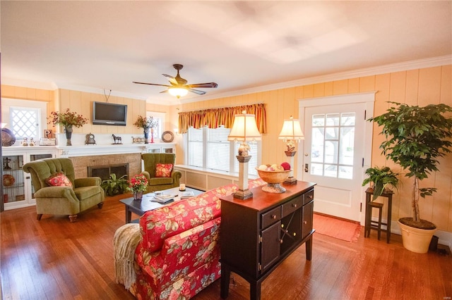 living room with crown molding, ceiling fan, and hardwood / wood-style floors