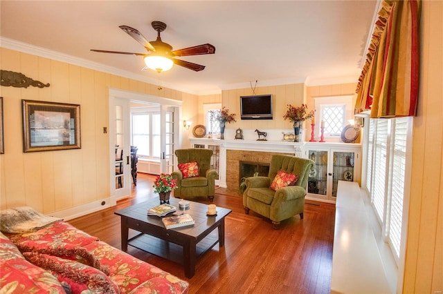 living room with hardwood / wood-style floors and crown molding