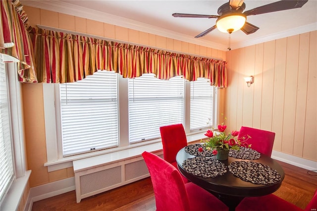 dining room with ceiling fan, ornamental molding, dark hardwood / wood-style flooring, and radiator