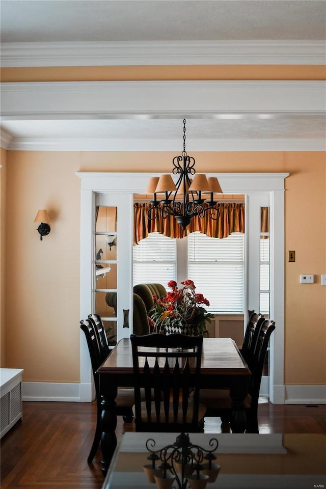 dining area with an inviting chandelier, dark hardwood / wood-style floors, and crown molding