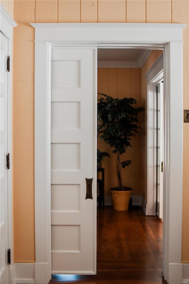 hall featuring ornamental molding and dark hardwood / wood-style floors